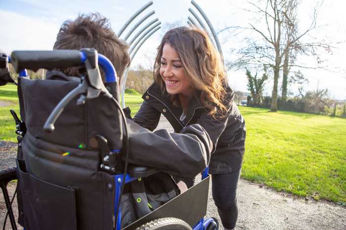 occupational therapist and girl in wheelchair