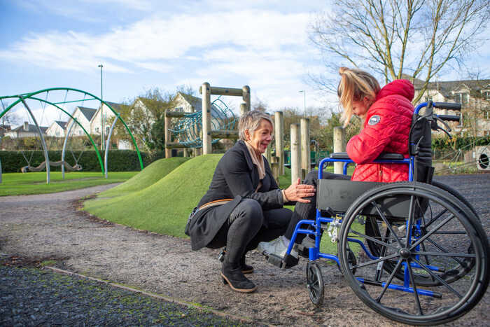 occupational therapist and girl in wheelchair