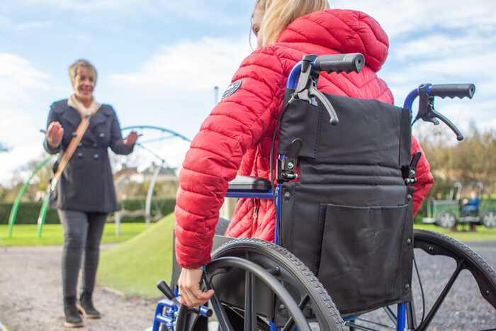 occupational therapist and girl in wheelchair