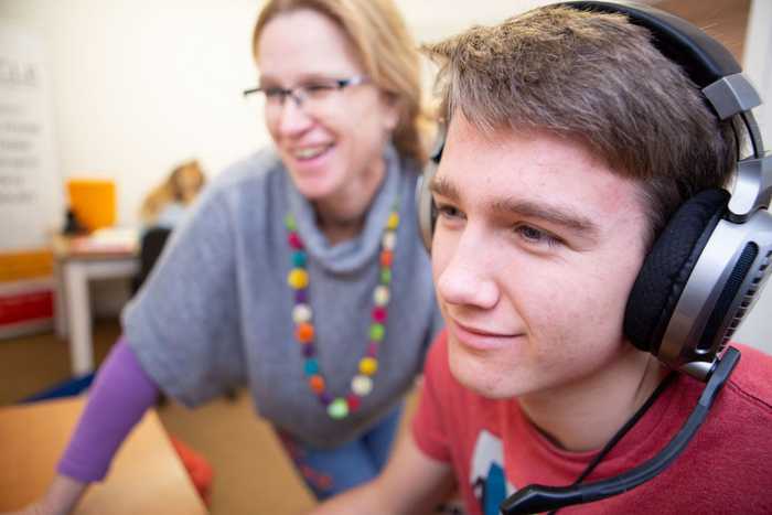 Case manager and young client wearing headphones